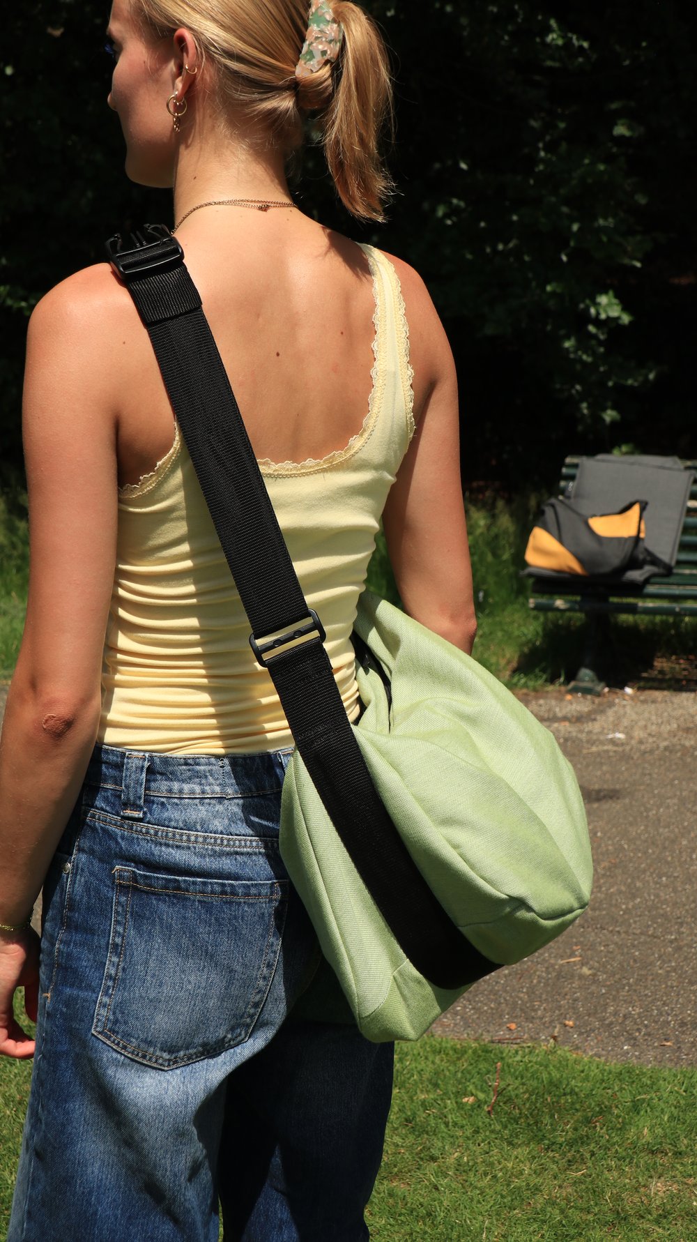 SHFT Bag worn in sage green, mustard colourway in the background